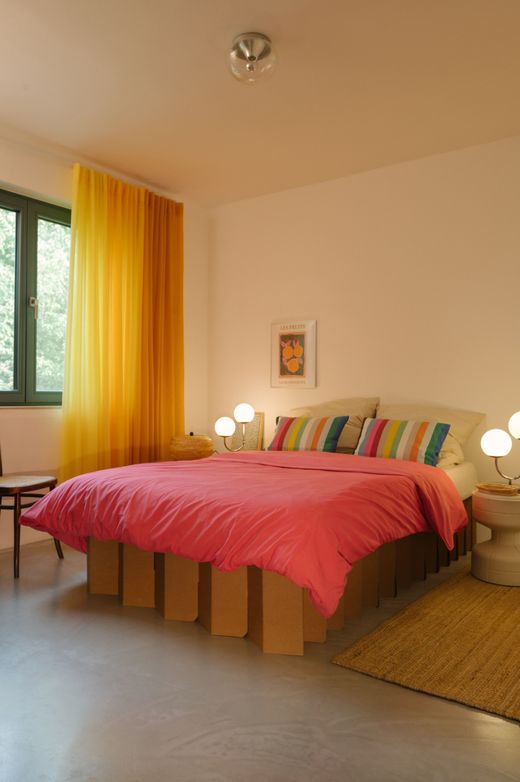 Schlafzimmer mit Lampe und grünem Vorhang